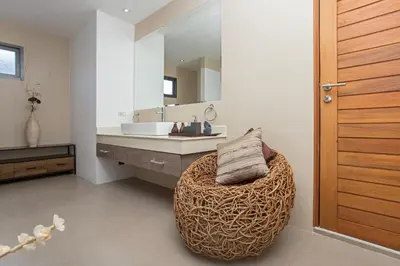 a bathroom with a round ottoman in front of a sink at Luxury 4BR Villa Virginie, Salt Pool, Rawai in Rawai Beach