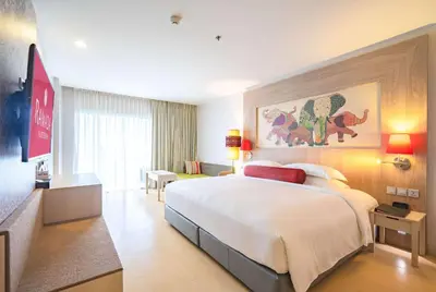 a bedroom with a large bed in a hotel room at Ramada by Wyndham Phuket Deevana in Patong Beach