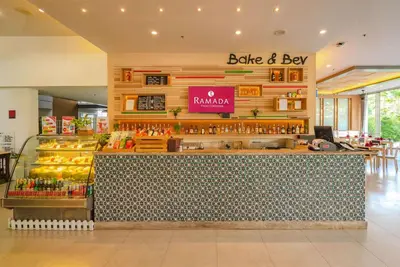 a store with a counter with a bottle and box at Ramada by Wyndham Phuket Deevana in Patong Beach