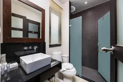 a bathroom with a sink and a toilet and a mirror at Villa Neya 2BR Private Pool Close to Naiharn Beach in Rawai Beach