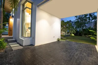 an open door of a house with a brick driveway at Luxury Villa in heart of Bang Tao! Villa BEAM in Laguna Phuket