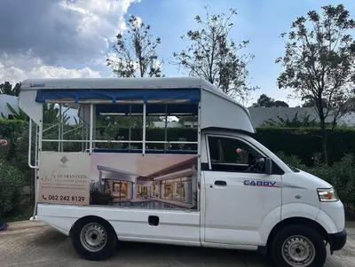 a white food truck with a house on the side at Luxury Villa in heart of Bang Tao! Villa BEAM in Laguna Phuket