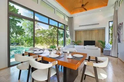 a dining room with a table and chairs at Luxury Villa in heart of Bang Tao! Villa BEAM in Laguna Phuket