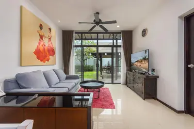 a living room with a couch and a tv at VILLA Hanga 3BR Private Pool Nai Harn Beach in Nai Harn Beach
