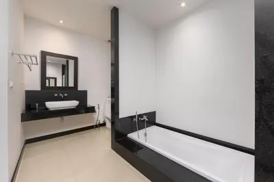 a bathroom with a bath tub and a sink at VILLA Hanga 3BR Private Pool Nai Harn Beach in Nai Harn Beach