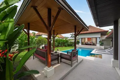 an outdoor pavilion with two benches and a swimming pool at Villa Iorangi 3 Bedroom Private Pool in Rawai Beach