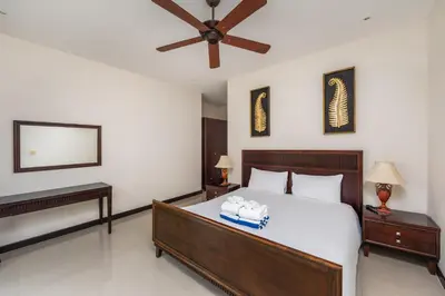 a bedroom with a large bed and two night stands at Villa Iorangi 3 Bedroom Private Pool in Rawai Beach