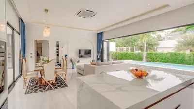 a kitchen and living room with a swimming pool at Bang Tao Luxury Villa - Menara Hill in Ban Phak Chit
