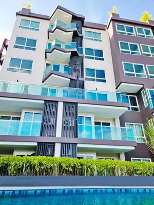 a building with a swimming pool in front of it at The City Condo Near Central Fest Phuket, Pool view in Ban Sam Kong