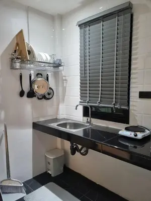 a kitchen with a sink and a window at Nua Tone Riverside Resort in Ban Thalat Choeng Thale