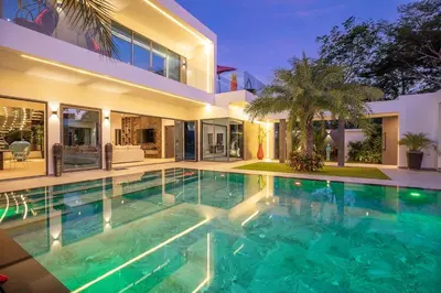 a swimming pool in front of a house at villa Lahaina in Rawai Beach