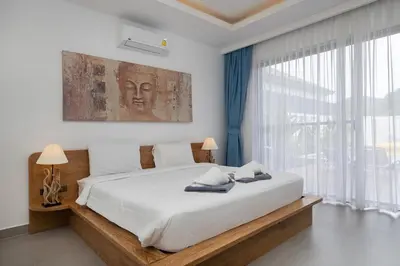 a bedroom with a large bed and a large window at Two-Bedroom Villa with Salt Pool in Rawai villa hapai in Rawai Beach