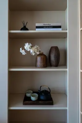 a book shelf with a vase and bowls on it at Stylish 1 bdr Kamala beach Roof Pool Gym free wifi in Kathu