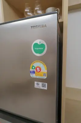 a close up of a refrigerator with stickers on it at Stylish 1 bdr Kamala beach Roof Pool Gym free wifi in Kathu