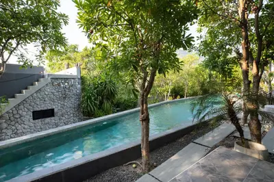 a swimming pool in the middle of a garden with trees at 1BR Pavilion Natural Park P07 Kamala Beach in Kamala Beach