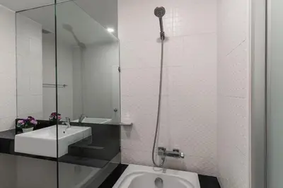 a bathroom with a sink and a glass shower at Karon Beach Hill View Appartment in Karon Beach