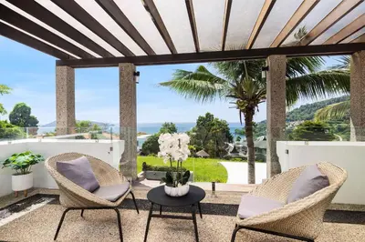a patio with two chairs and a table at Spectacular Ocean Views 8BR Pool Villa Sawan in Patong! Relax & Play - Billiard, Table football, Gym & Sauna! in Patong Beach