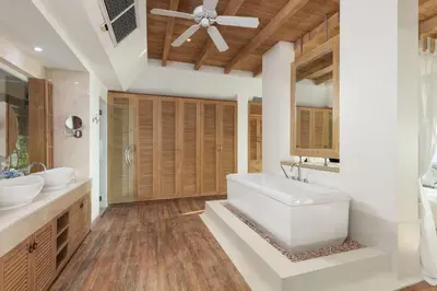 a bathroom with a white tub and two sinks at Spectacular Ocean Views 8BR Pool Villa Sawan in Patong! Relax & Play - Billiard, Table football, Gym & Sauna! in Patong Beach