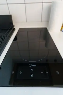a black stove top oven in a kitchen at Dream 1 BdR Kamala Beach Free Parking WiFi Gym in Kathu