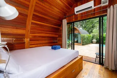 a bedroom with a bed and a large window at New 3BR Chalet-Style Villa Pasak Paradise 3, Private Pool, 10min drive to Laguna Phuket in Bang Tao Beach
