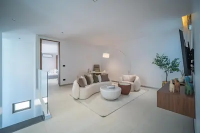 a living room with a couch and a table at Grand View Residence Villa by NLA in Bang Tao Beach