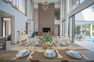 a dining room with a table with blue and white dishes at Grand View Residence Villa by NLA in Bang Tao Beach