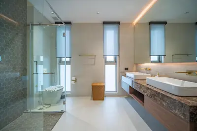 a bathroom with two sinks and a glass shower at Grand View Residence Villa by NLA in Bang Tao Beach
