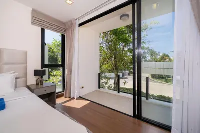 a bedroom with a bed and a large window at Phuket villa in Laguna in Bang Tao Beach