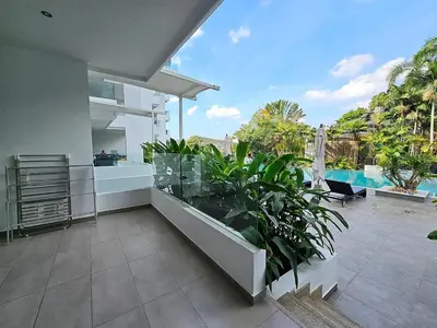 a balcony of a house with a swimming pool at Stylish 2 Bedroom Apartment with pool access in Surin in Surin Beach