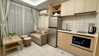 a kitchen with a refrigerator and a chair in it at Fantasea Kamala 1 BR Near Fantasea Show & Beach 505 in Phuket Town