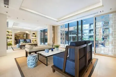 a living room with a couch and a tv at The Base Height Condo with Rooftop infinity pool in Ban Sam Kong