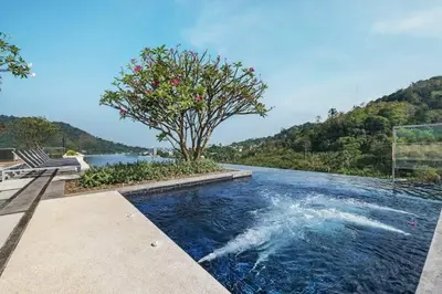 a pool of water with a tree in the middle at The Base Height Condo with Rooftop infinity pool in Ban Sam Kong