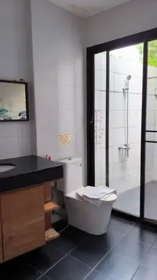a bathroom with a toilet and a sink and a shower at Rosemary Phuket in Ban Tha Rua
