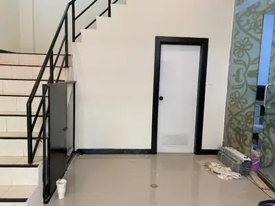 a hallway with a door and stairs in a building at Wink City 4th Patong in Patong Beach