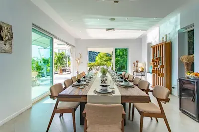 a long dining room with a long table and chairs at Seaview 10 bedroom villa Bangtao beach area in Ban Thalat Choeng Thale