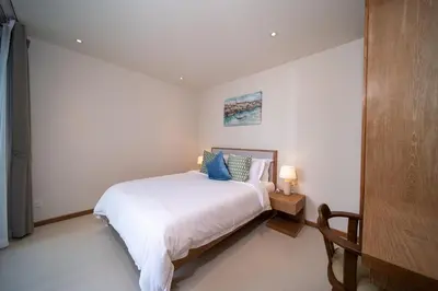 a bedroom with a bed in a white room at Modern 3BR Pool Villa T-Breeze in Laguna Phuket
