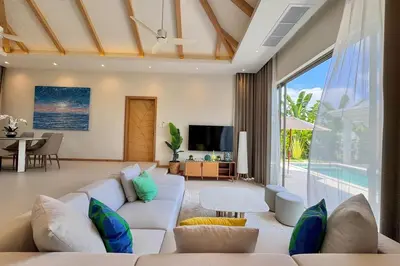 a living room with a white couch and a table at Modern 3BR Pool Villa T-Breeze in Laguna Phuket