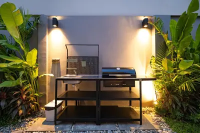 a desk with a mirror on top of it with plants at Stylish Mansion for Leisure with Garden & Pool in Laguna Phuket