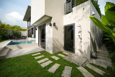 a modern house with a swimming pool and a yard at Stylish Mansion for Leisure with Garden & Pool in Laguna Phuket