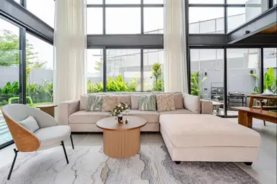 a living room with a couch and a table and chairs at Stylish Mansion for Leisure with Garden & Pool in Laguna Phuket