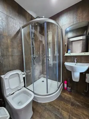 a bathroom with a shower and a toilet and a sink at Modern 3-Bedroom Townhome in Kamala in Kamala Beach