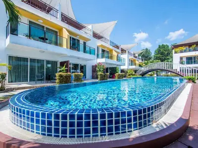 a swimming pool in front of a building at Modern 3-Bedroom Townhome in Kamala in Kamala Beach