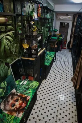 a restaurant with green plants on the walls at Tropical Vibes Mini Hostel in Phi Phi Don