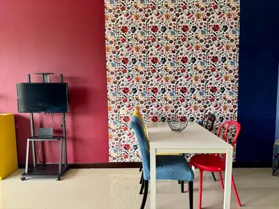 a dining room with a table and chairs and a wall at Stylish Sea view Chic condo in Karon Beach