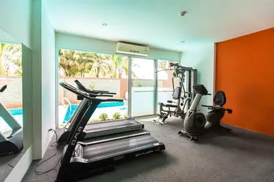 a room with a gym with a treadmill and a exercise bike at Stylish Sea view Chic condo in Karon Beach