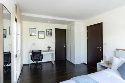 a bedroom with a bed and a desk and a chair at Rawai beach 1br apartment at The Title in Rawai Beach