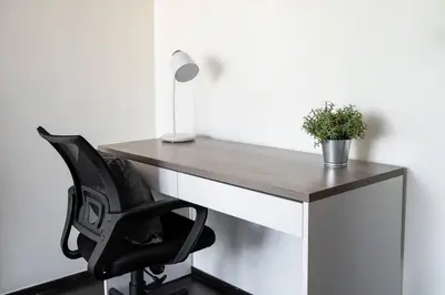a desk with a black chair and a lamp at Rawai beach 1br apartment at The Title in Rawai Beach