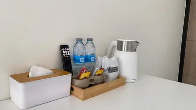 a counter with a bottle of water and a thermos at Suntalee House in Nai Yang Beach
