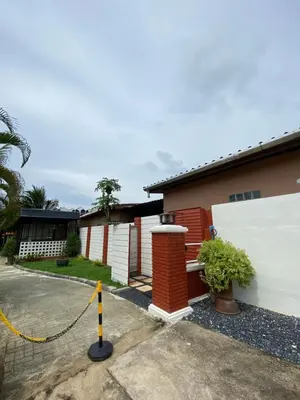 a house with a yellow rope around it at Suntalee House in Nai Yang Beach