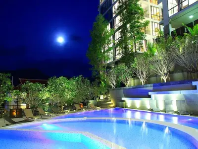 a large swimming pool in a building at night at Luxury 2-Bedroom Penthouse with Seaview Kamala in Kamala Beach